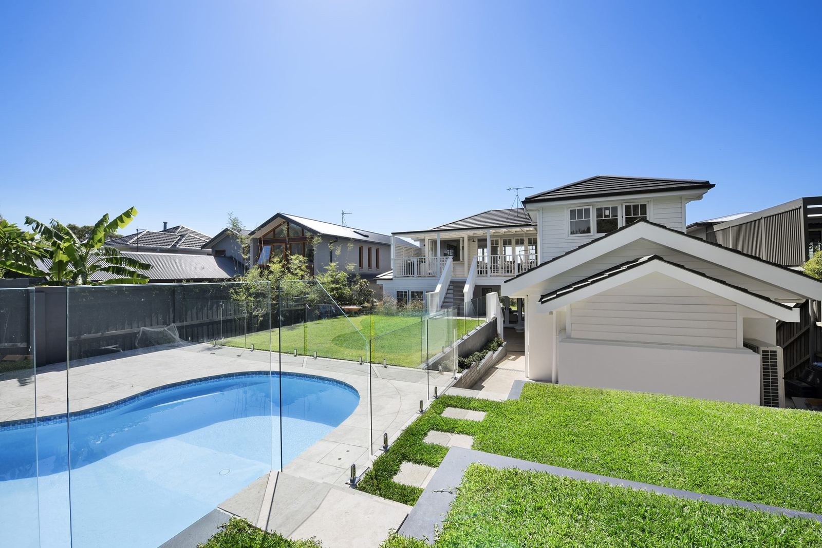 Balgowlah Heights, rear garden with swimming pool, glass fencing, lawn and garage, built by HP Constructions with All Australian Architecture