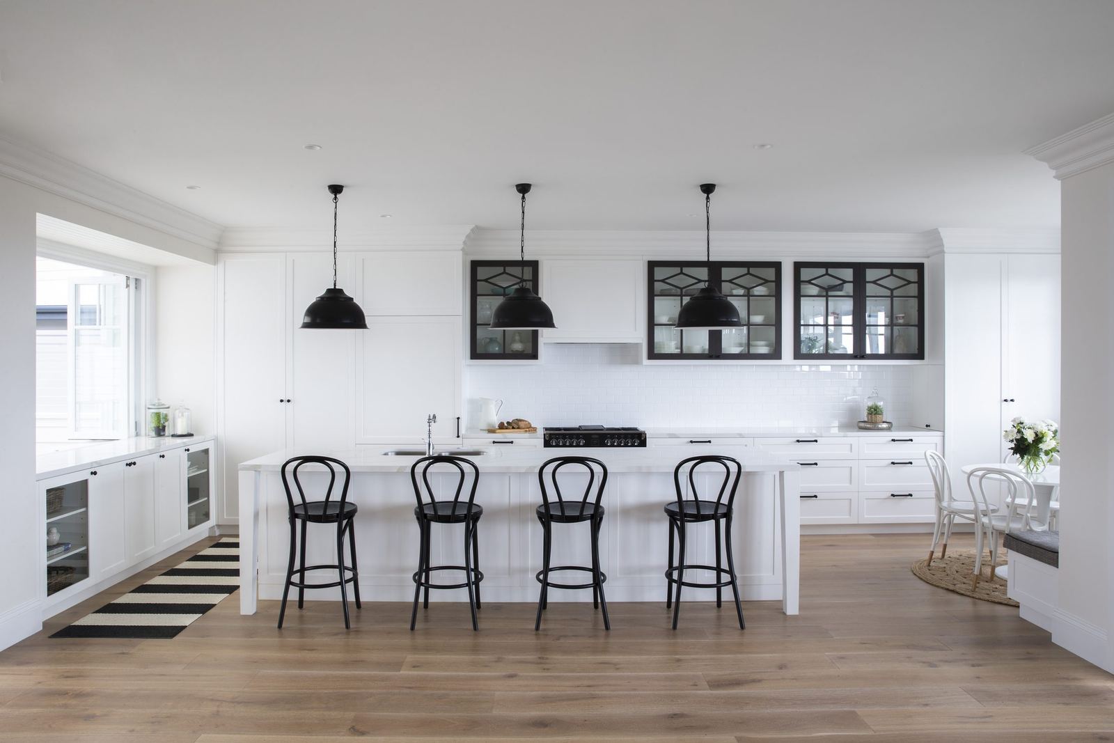 Balgowlah Heights, white kitchen island with black pendants, bentwood stools and timber floor, built by HP Constructions with All Australian Architecture
