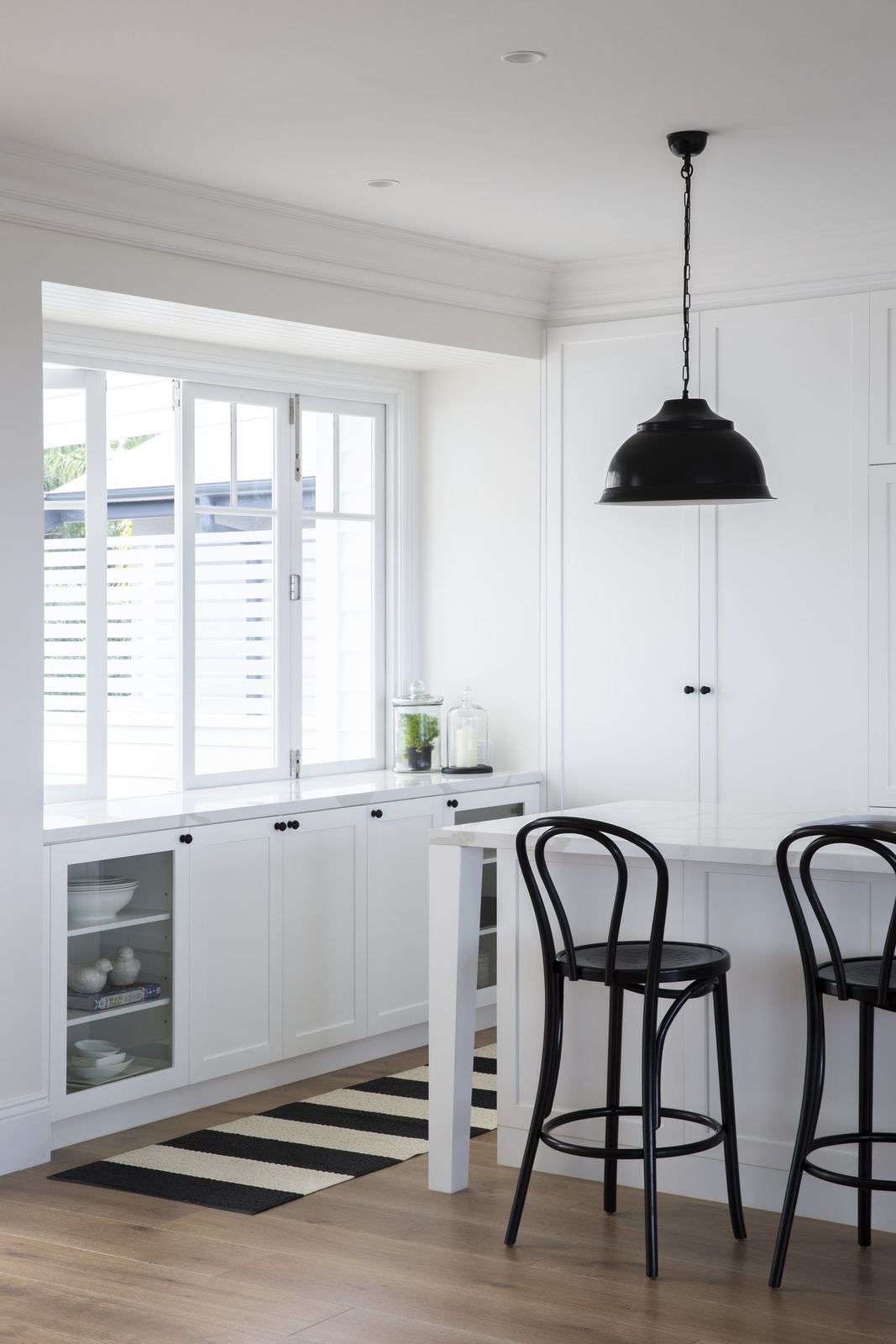 Balgowlah Heights, kitchen nook with high white table, black bentwood stools and pendant, built by HP Constructions with All Australian Architecture