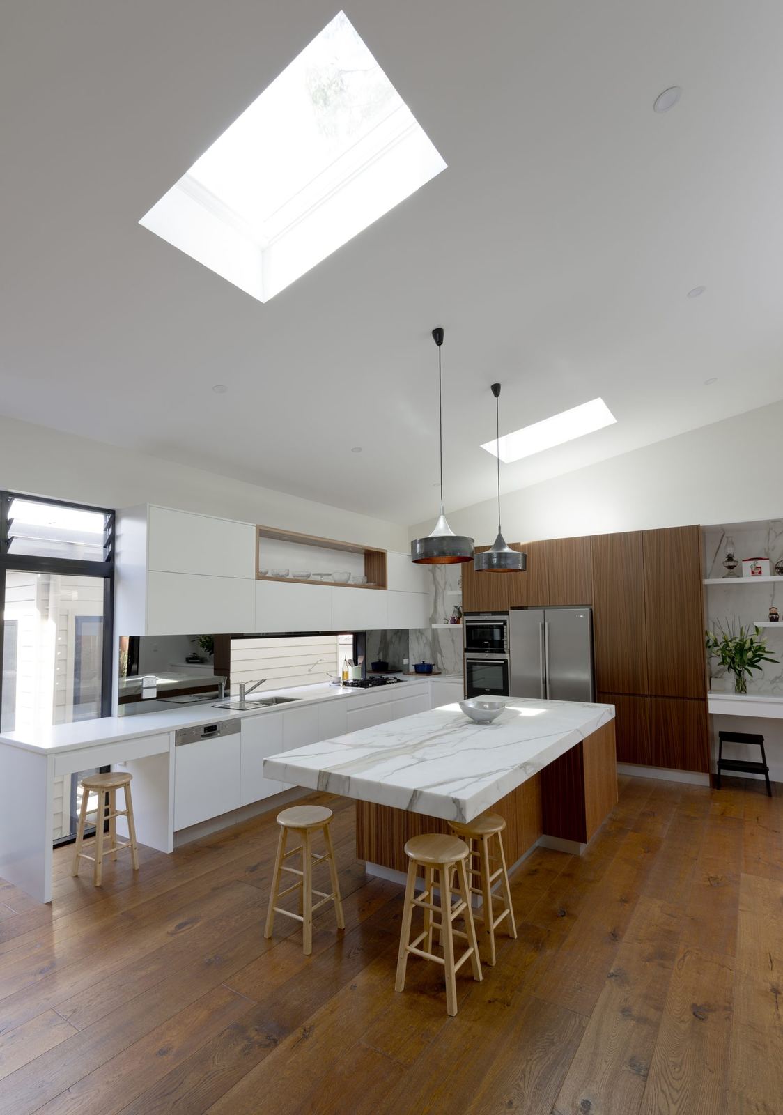 Balgowlah, white kitchen island with stone benchtop, bar stools and skylight above, built by HP Constructions with Scope Architects