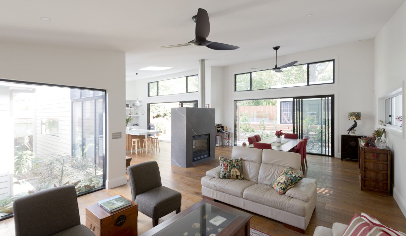 Balgowlah, open living room with fireplace, ceiling fan and view to the kitchen, built by HP Constructions with Scope Architects