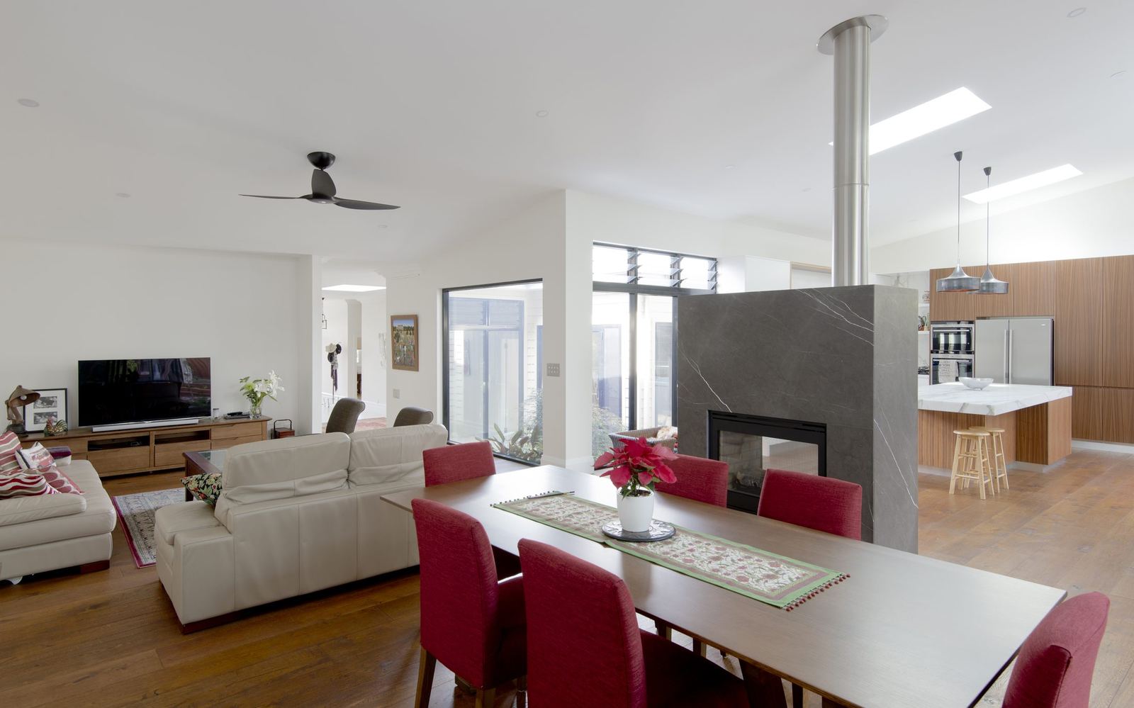 Balgowlah, open-plan living and dining with a stone fireplace and dining table, built by HP Constructions with Scope Architects