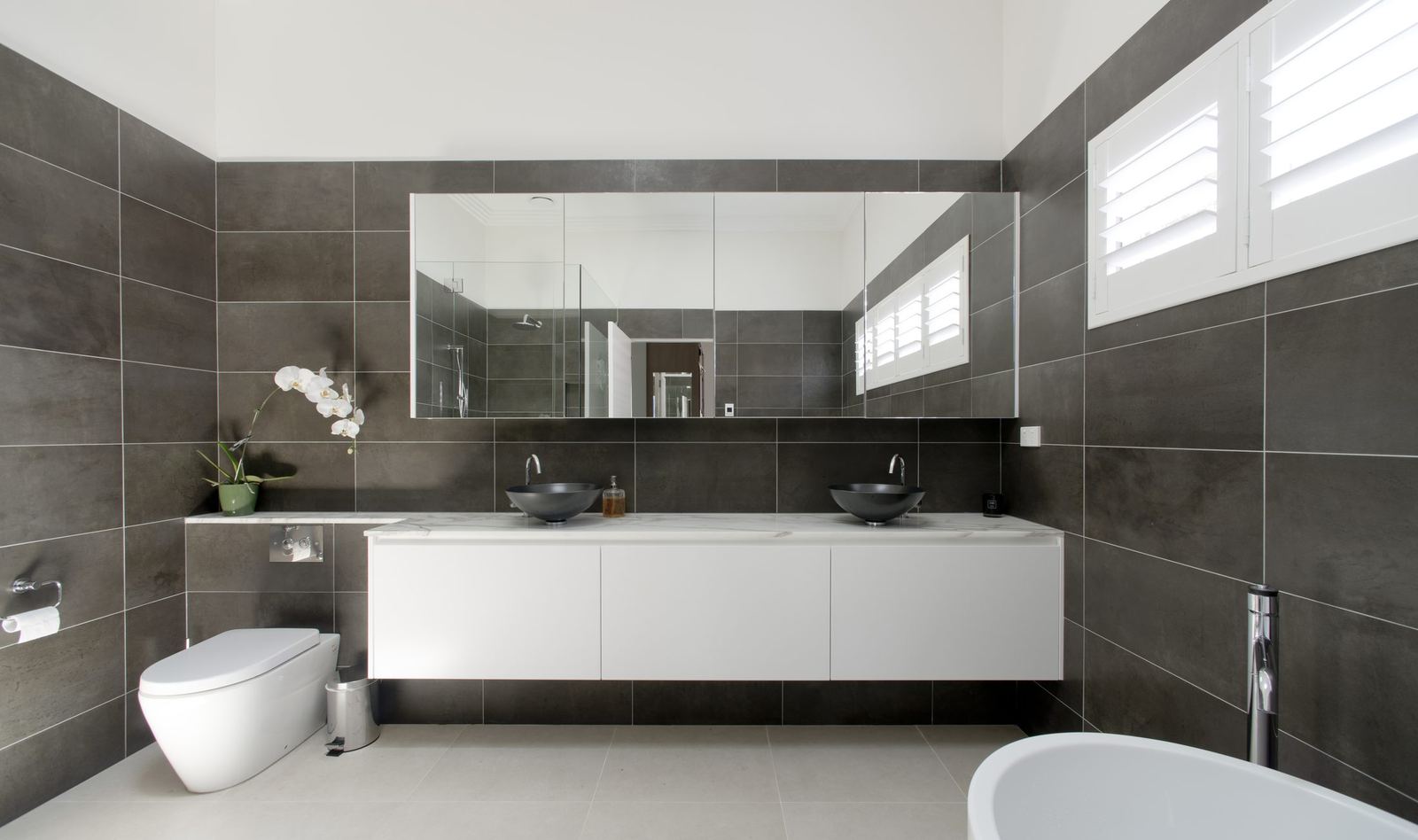Balgowlah, bathroom with charcoal tiles, floating double vanity and freestanding bath, built by HP Constructions with Scope Architects