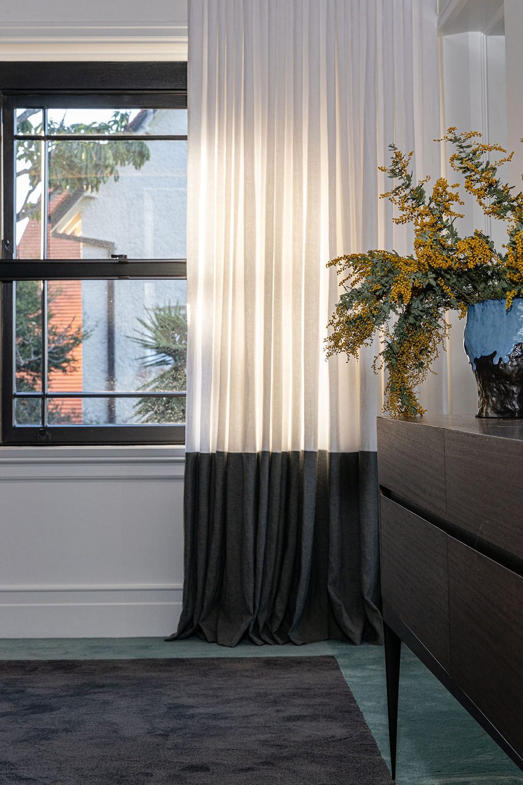 Bellevue Hill, bedroom corner with black-framed window, sheer curtains and timber sideboard, built by HP Constructions with Foster & Associates
