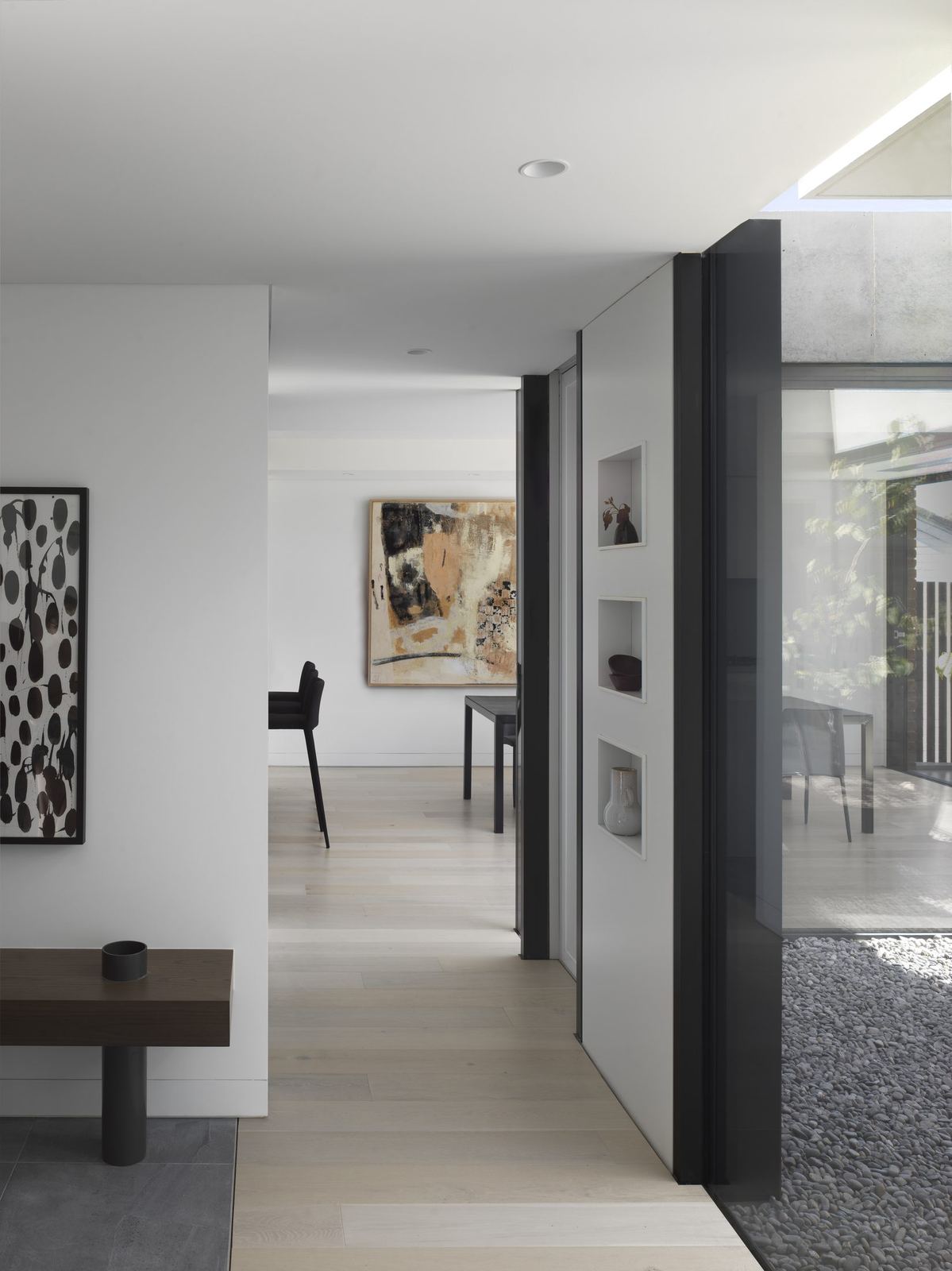 Castle Cove, gallery corridor hung with artwork opening to living space, built by HP Constructions with Dieppe Design