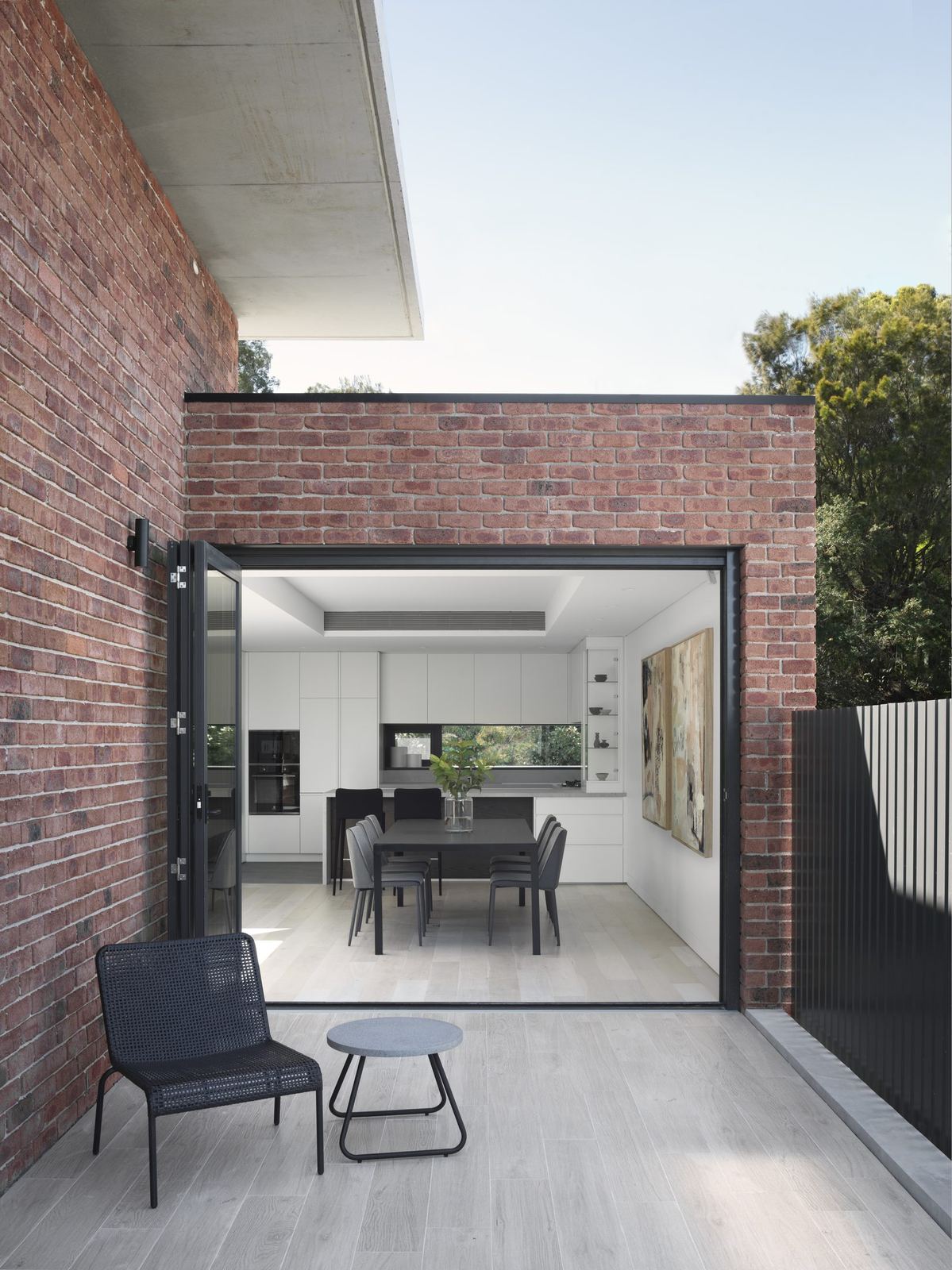 Castle Cove, brick wall with sliding door open to dining and terrace, built by HP Constructions with Dieppe Design