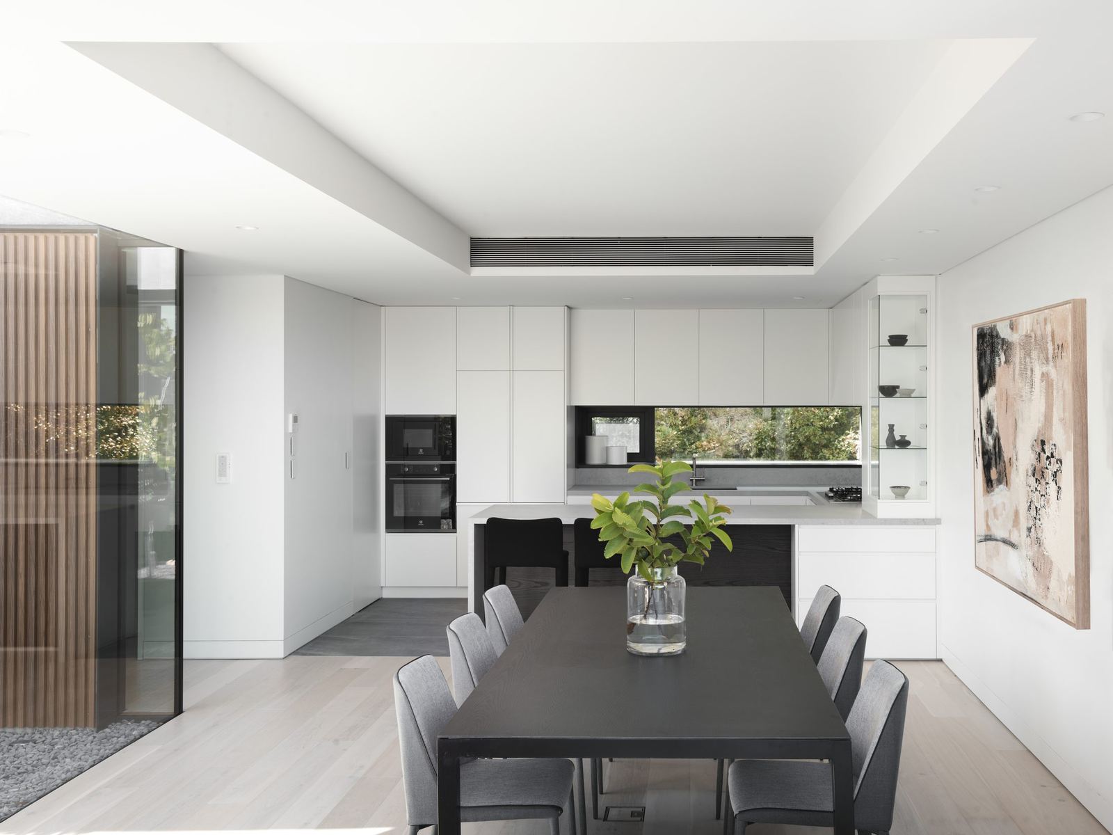 Castle Cove, white kitchen and dining with black table and timber joinery, built by HP Constructions with Dieppe Design