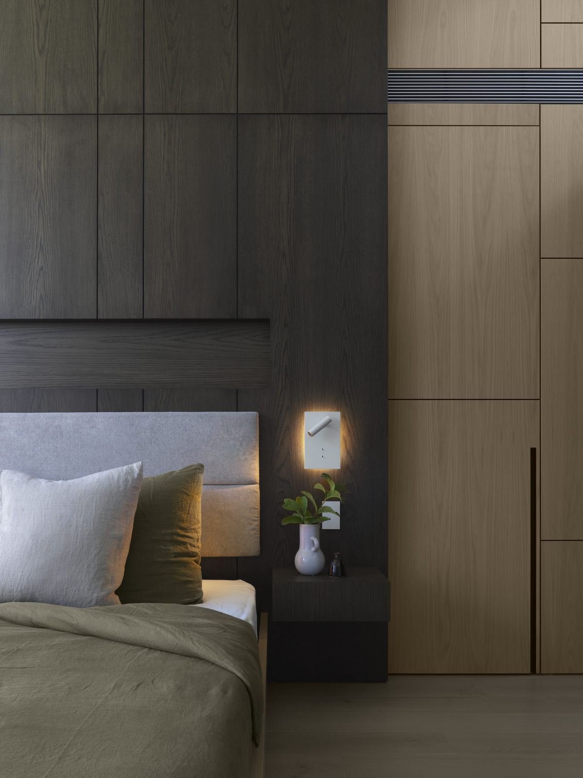 Castle Cove, bedroom with timber joinery, green bedding and wall light, built by HP Constructions with Dieppe Design