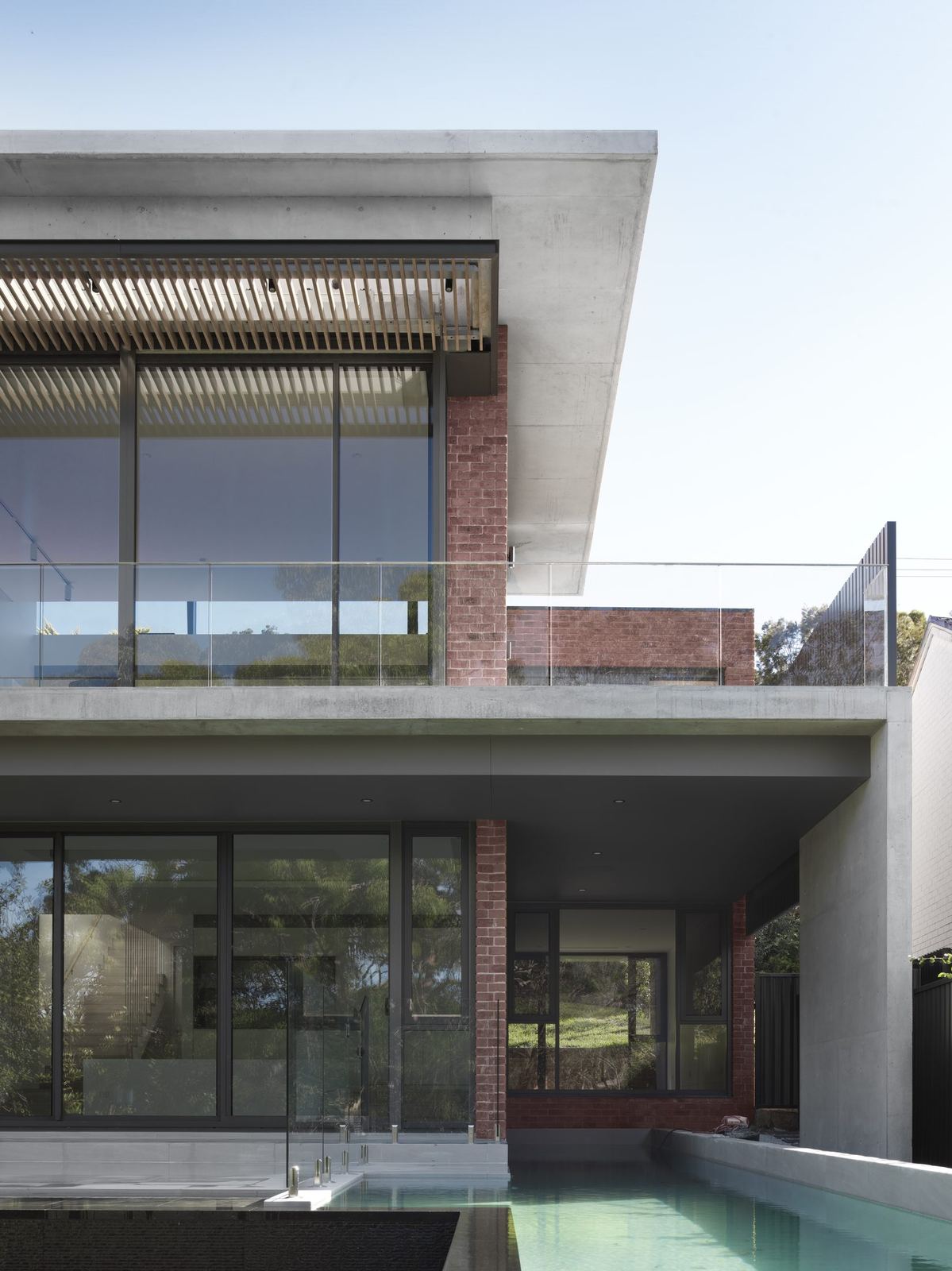 Castle Cove, brick and glass exterior with swimming pool below, built by HP Constructions with Dieppe Design