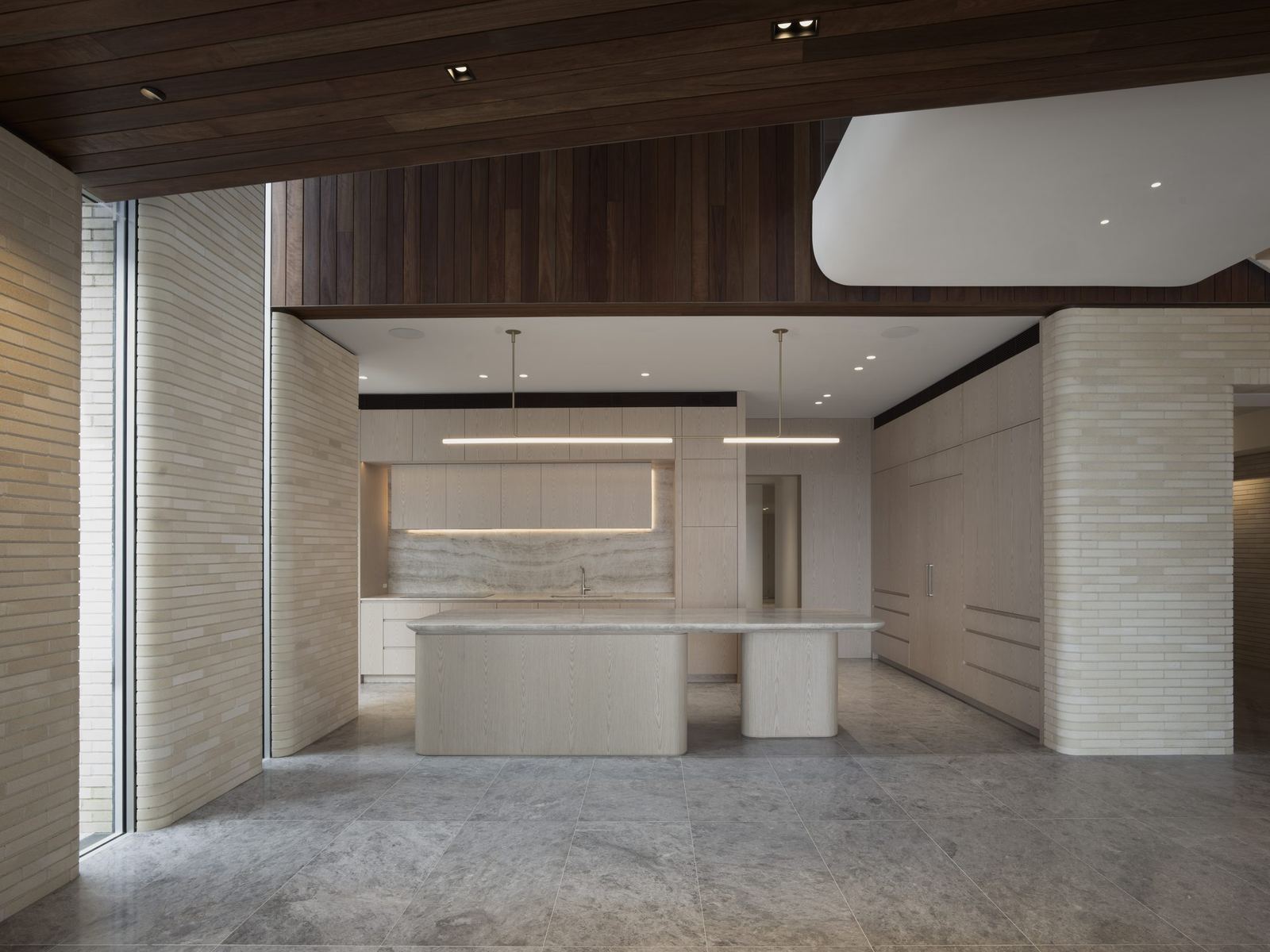 Castlecrag, kitchen with stone island, travertine walls and timber-lined ceiling, built by HP Constructions with FJC Studio