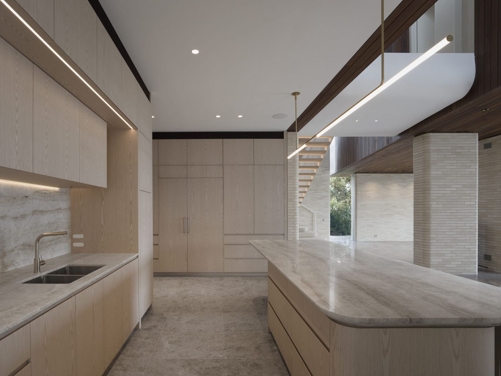 Castlecrag, kitchen with pale timber joinery, stone island and linear pendant, built by HP Constructions with FJC Studio