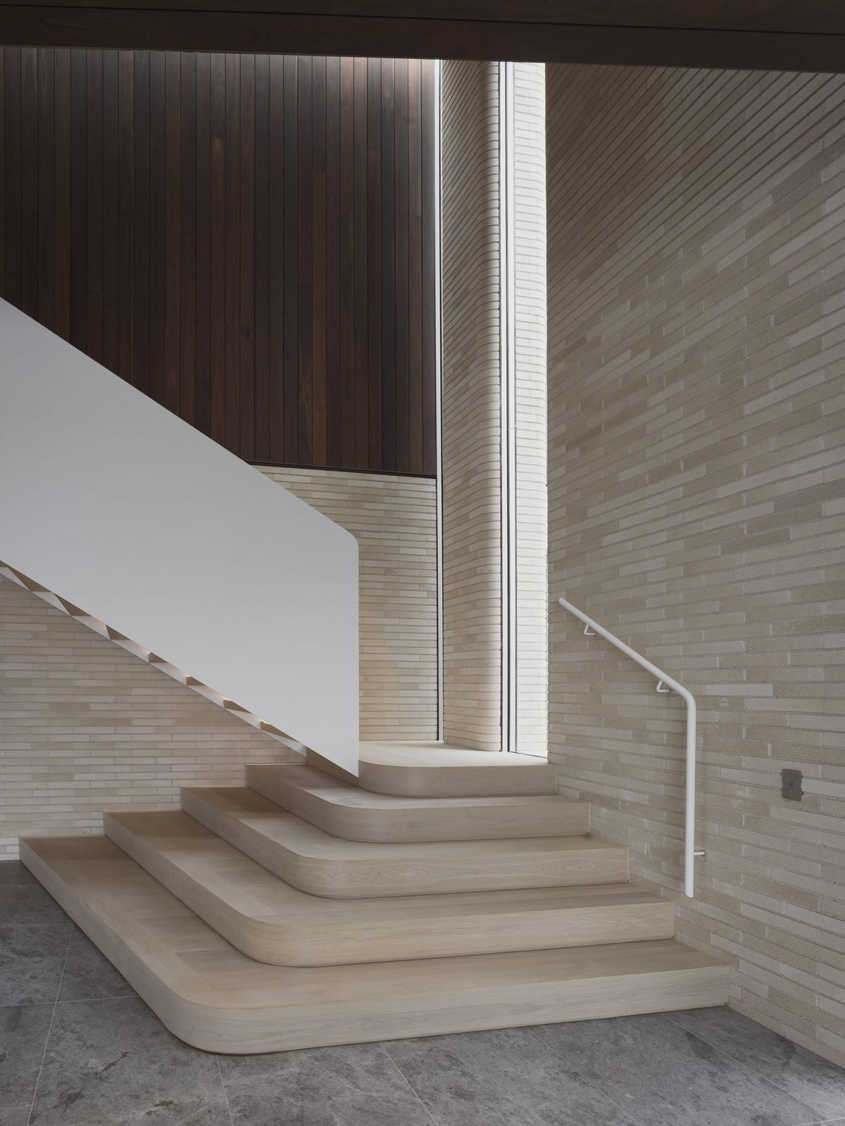 Castlecrag, curved travertine staircase detail against timber-clad wall, built by HP Constructions with FJC Studio
