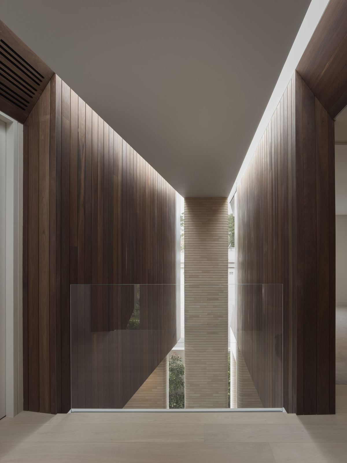 Castlecrag, corridor lined with timber walls and stone flooring, built by HP Constructions with FJC Studio