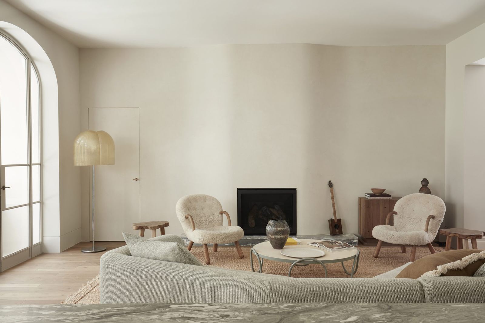 Darling Point, living room with arched windows, fireplace and curved sofa, built by HP Constructions with Hancock Architects