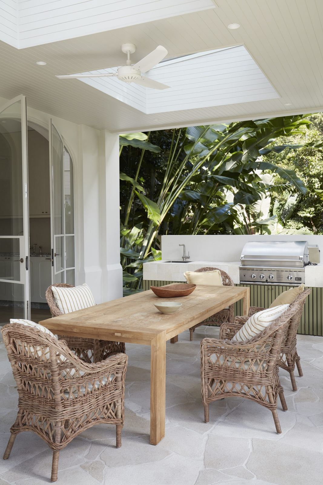 Darling Point, covered terrace with timber dining table, wicker chairs and skylight, built by HP Constructions with Hancock Architects