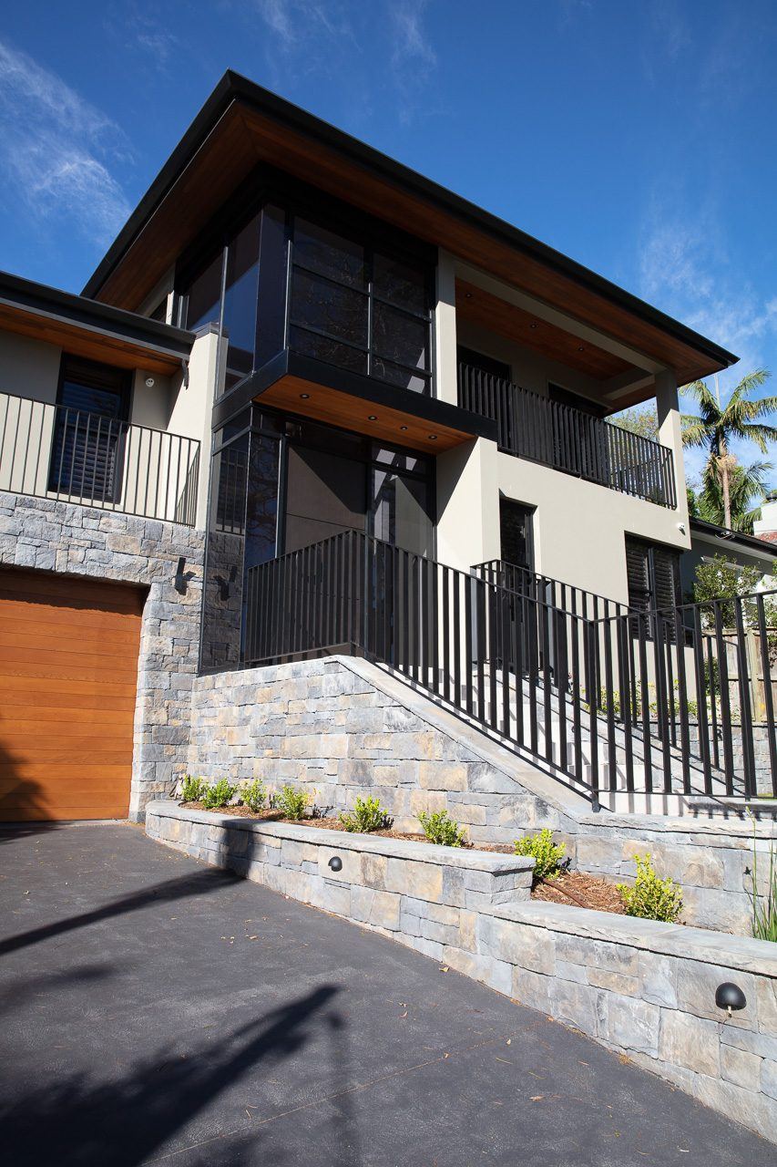 Hunters Hill, street view of multi-level home with stone base and metal fencing, built by HP Constructions with Dale Design Group