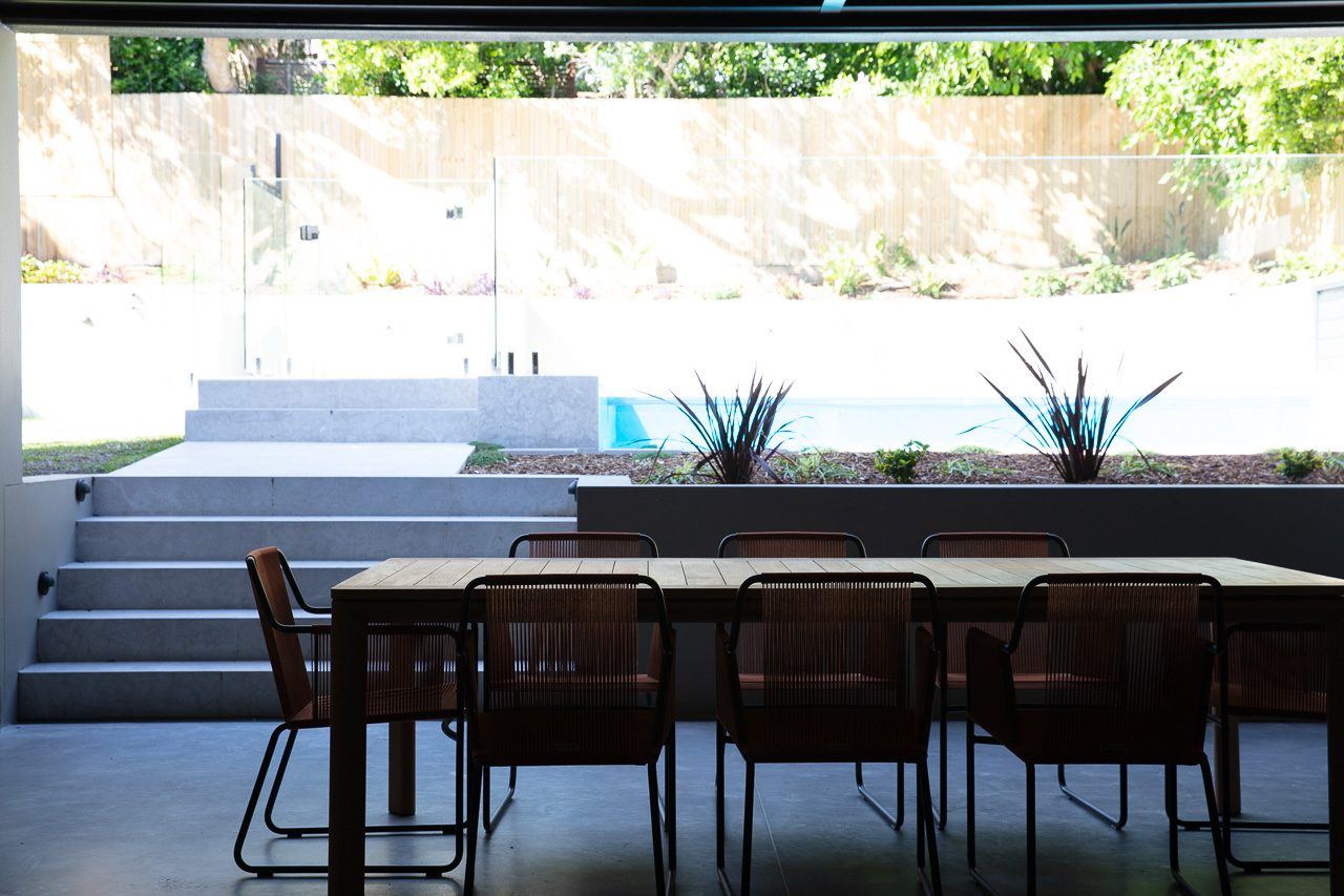 Hunters Hill, covered terrace dining table opening onto pool and stepped garden, built by HP Constructions with Dale Design Group