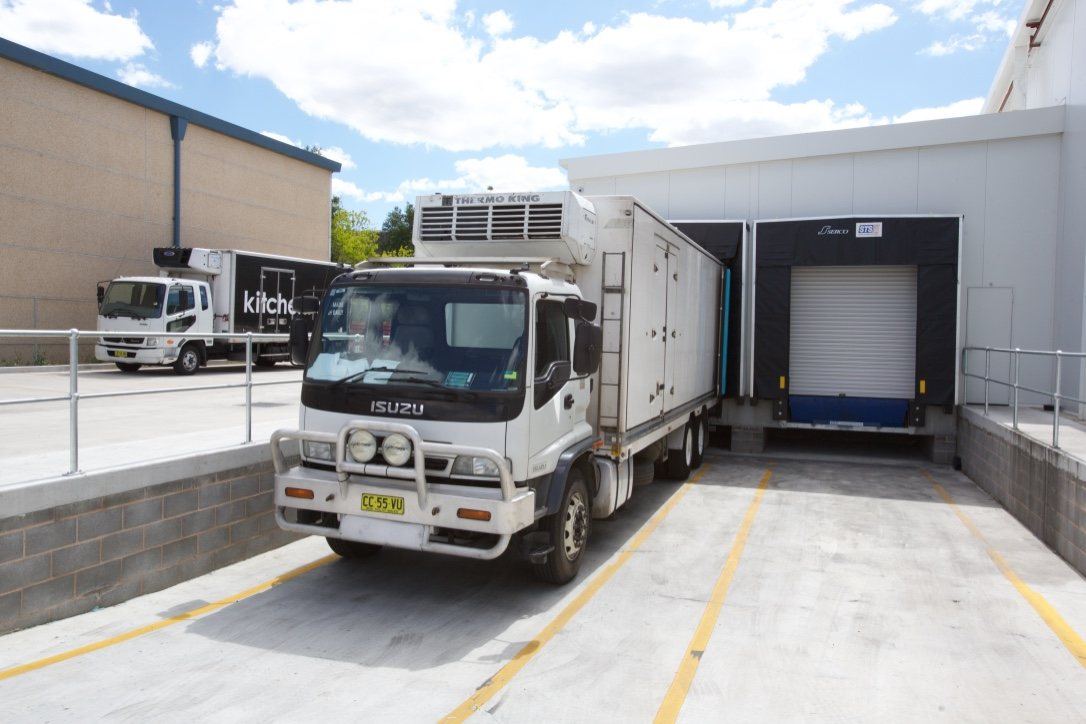 Kitchen Food Company, refrigerated Isuzu truck reversed into a concrete loading dock, built by HP Constructions