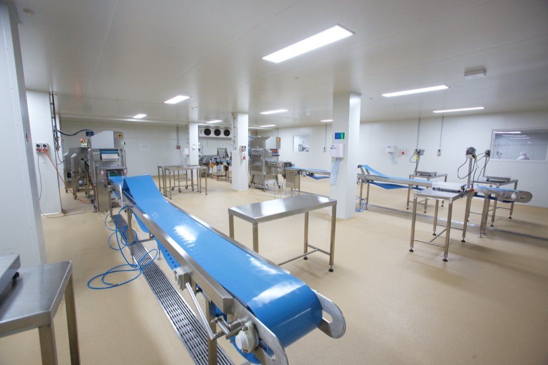 Kitchen Food Company, production line with blue conveyor belts and stainless tables, built by HP Constructions