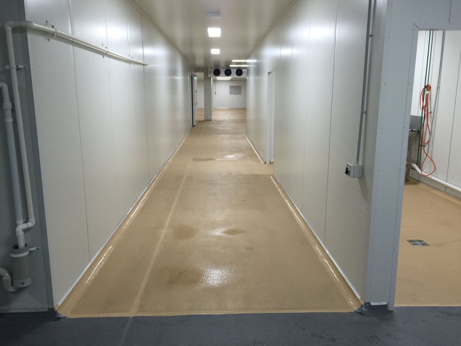 Kitchen Food Company, long refrigerated cold-store corridor with white panel walls, built by HP Constructions
