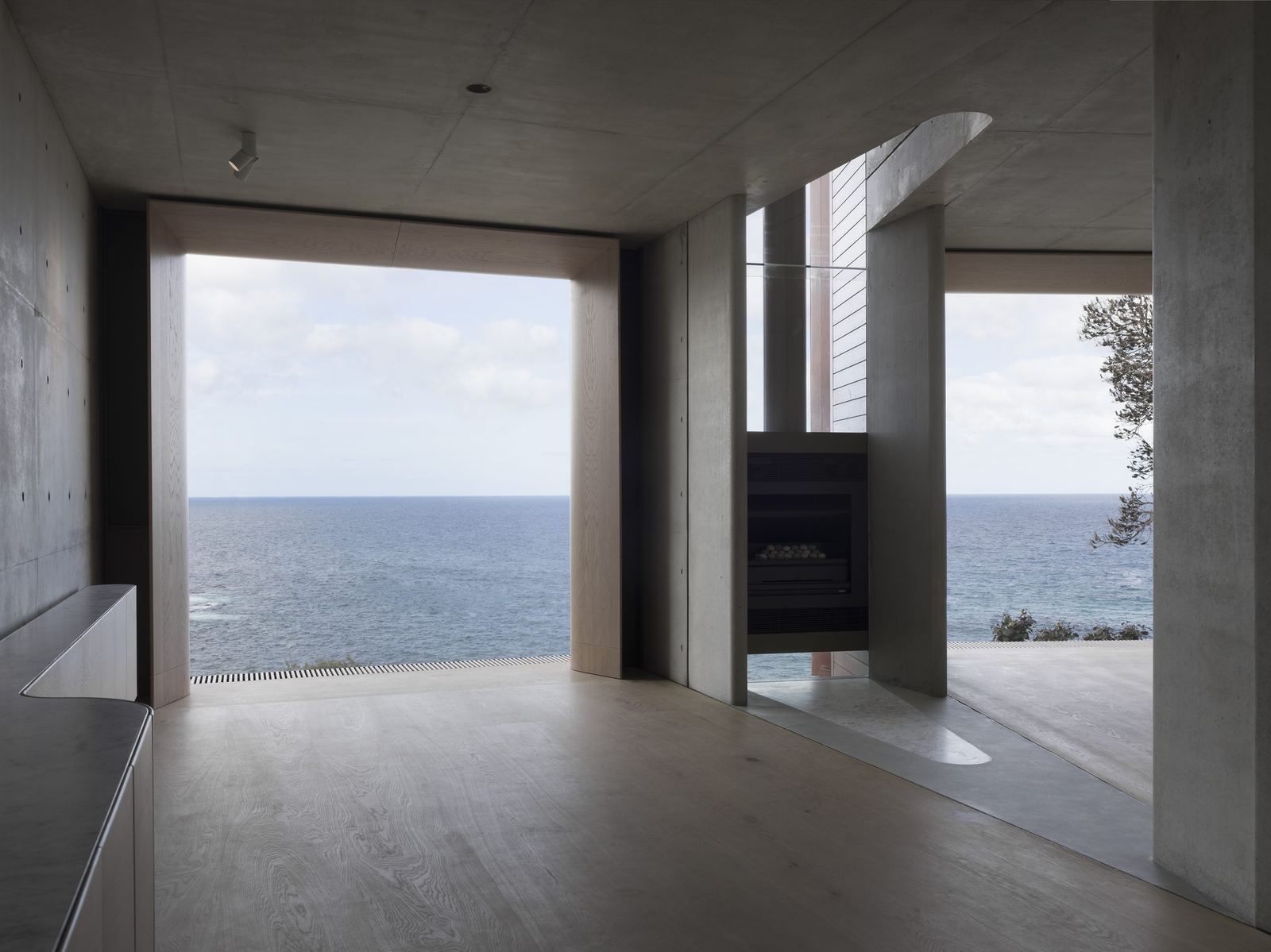 Lurline Bay, living room with floor-to-ceiling ocean glazing and off-form concrete walls, built by HP Constructions with FJC Studio