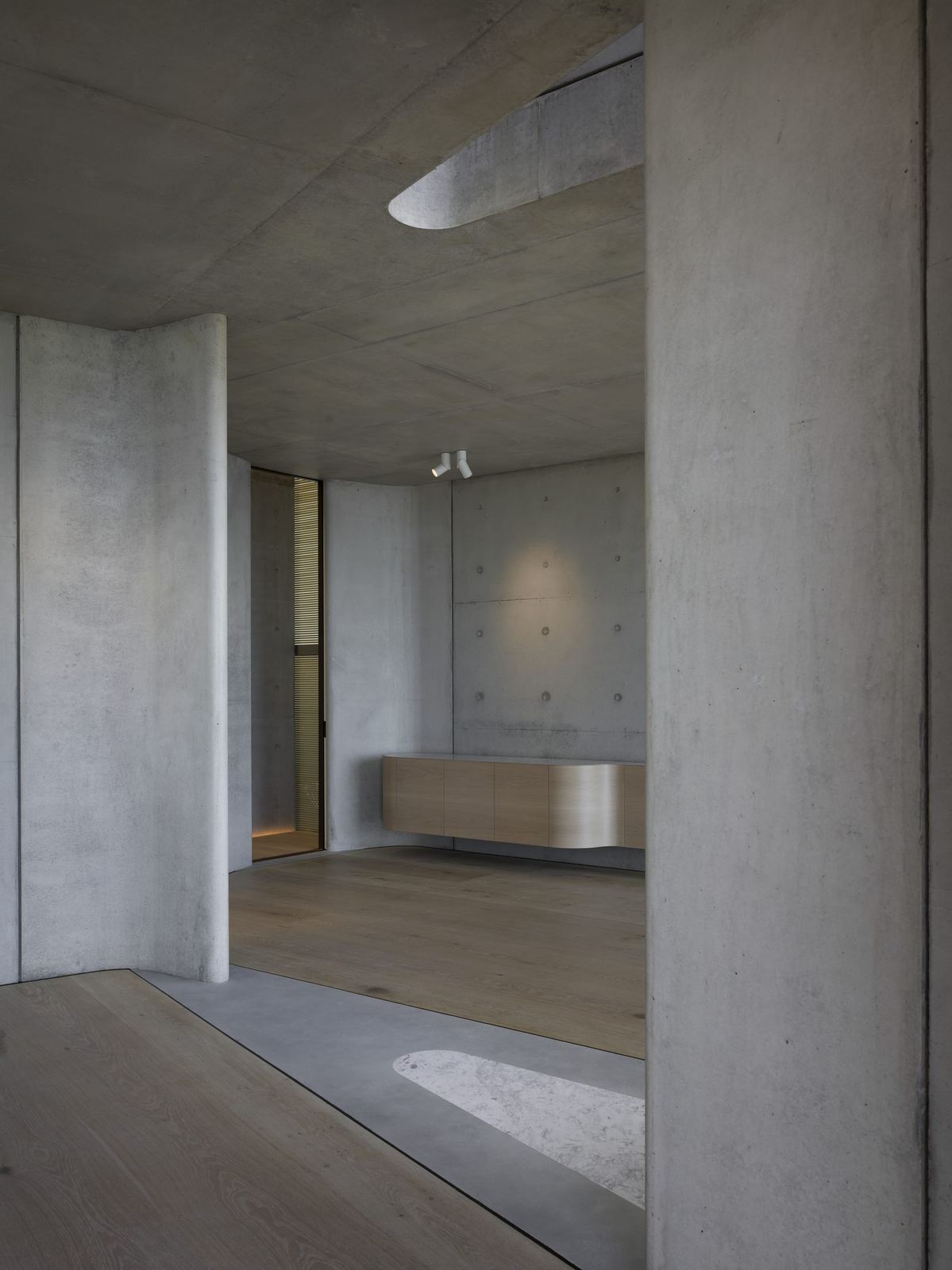 Lurline Bay, off-form concrete interior with timber joinery and a framed opening, built by HP Constructions with FJC Studio