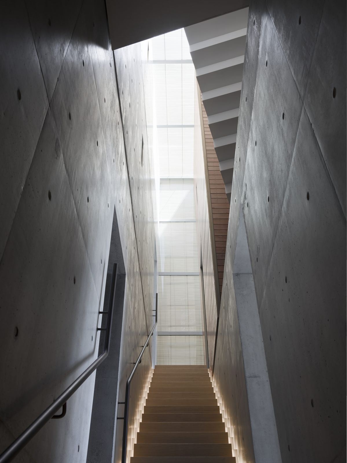 Lurline Bay, concrete stair void rising to a skylight, built by HP Constructions with FJC Studio