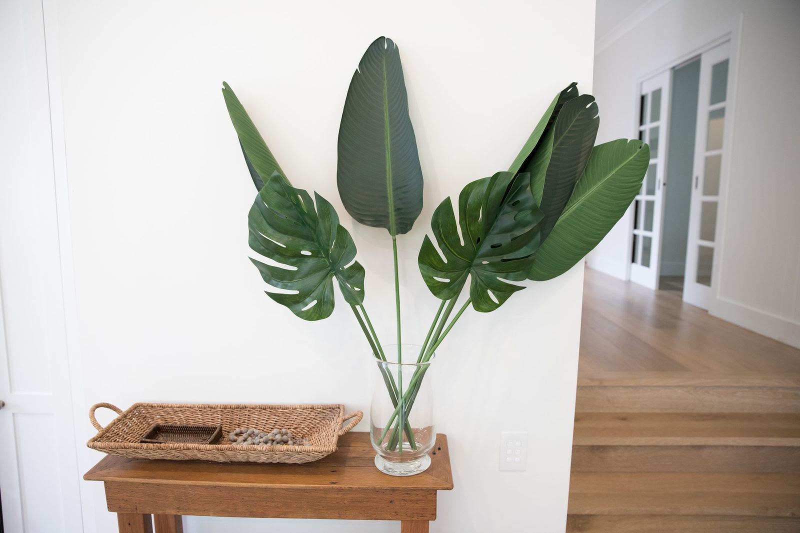 North Balgowlah, timber side table styled with vase of large green leaves, built by HP Constructions with J.D Evans & Co