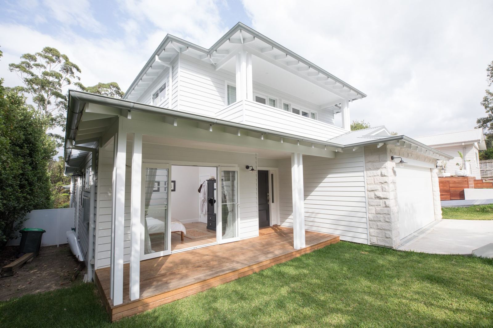 North Balgowlah, rear elevation of white weatherboard home with upper balcony, built by HP Constructions with J.D Evans & Co