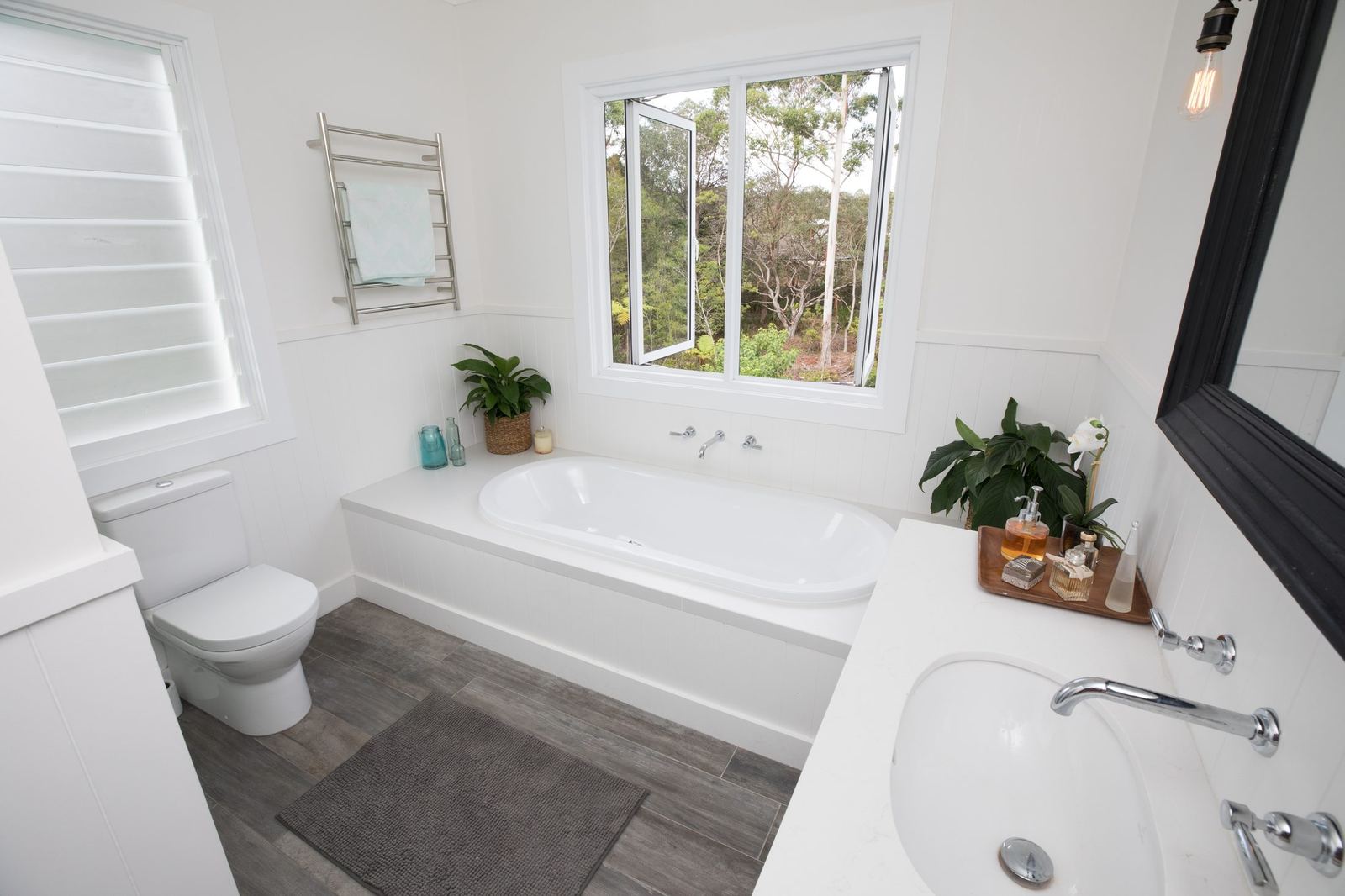 North Balgowlah, bathroom with white bathtub, heated towel rail and window, built by HP Constructions with J.D Evans & Co