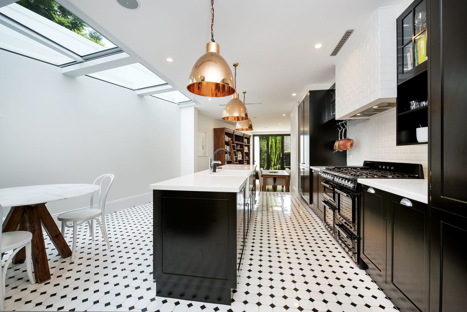 Paddington, kitchen with black joinery, white island, skylights and patterned floor tiles, built by HP Constructions with Gutnik Design Group