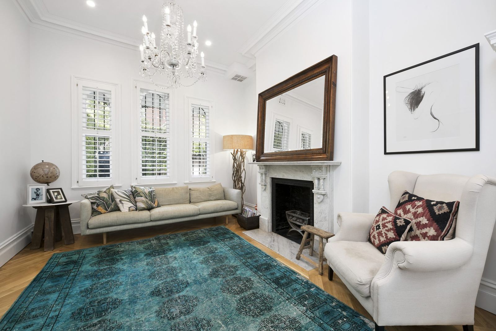 Paddington, formal sitting room with fireplace, chandelier and plantation shutters, built by HP Constructions with Gutnik Design Group