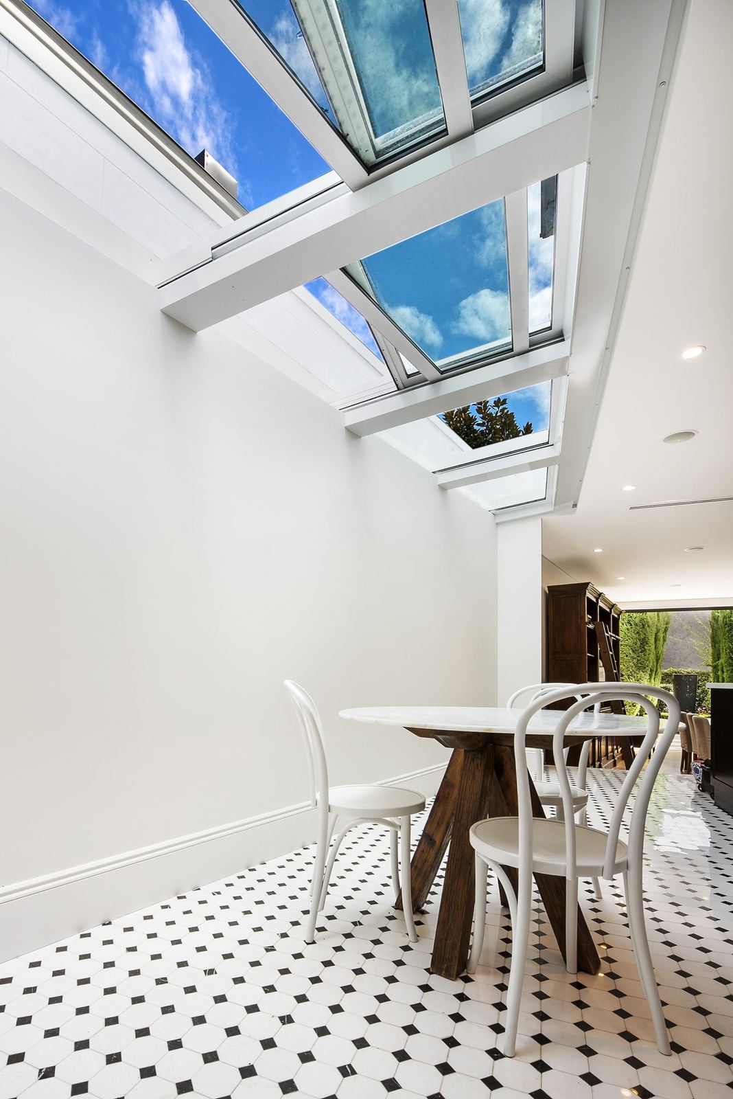 Paddington, dining nook beneath angled glass atrium roof with patterned tiles, built by HP Constructions with Gutnik Design Group