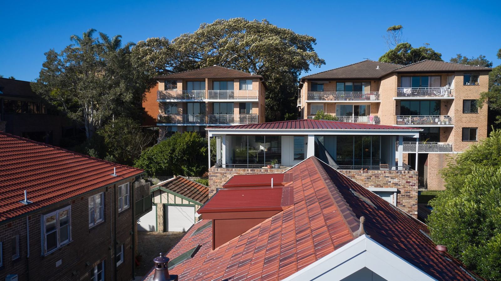 Queens Park Apartments, aerial exterior of apartment building among rooftops and trees, built by HP Constructions with Ignite Architects