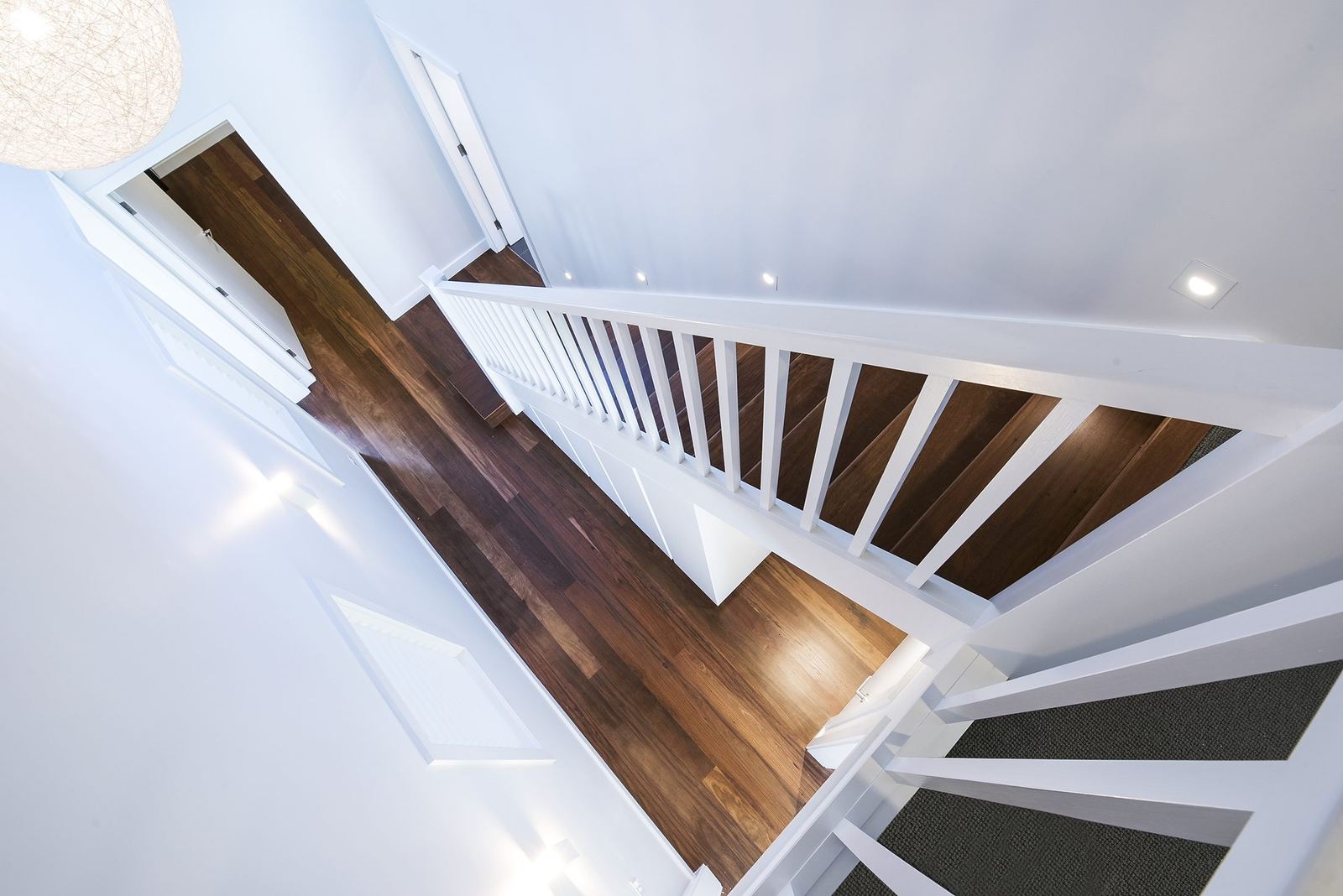 Seaforth, overhead view of a timber staircase with white balustrade and carpet, built by HP Constructions with Playoust Churcher