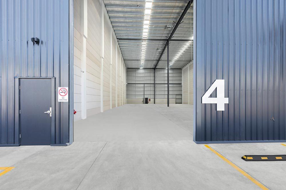 Thornleigh Warehouse, warehouse interior at roller-door entrance with large number four, built by HP Constructions