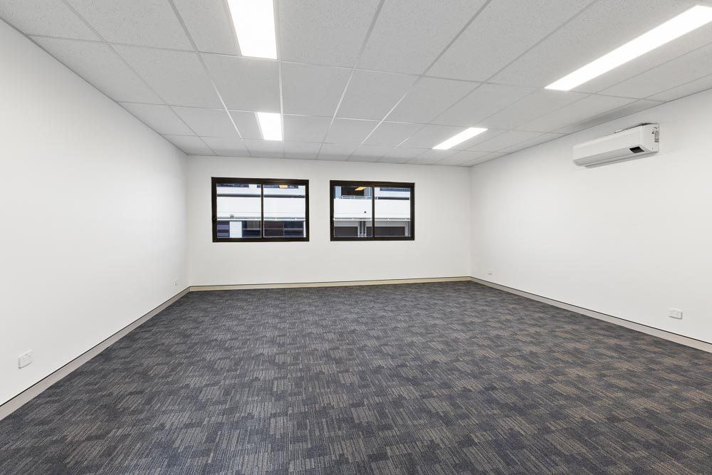 Thornleigh Warehouse, empty carpeted office suite with windows and ceiling tiles, built by HP Constructions