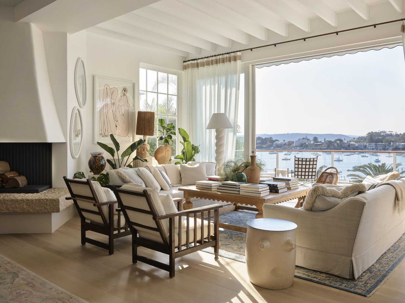 Vaucluse, living room with fireplace and sliding doors opening to harbour views, built by HP Constructions with Alexander & Co