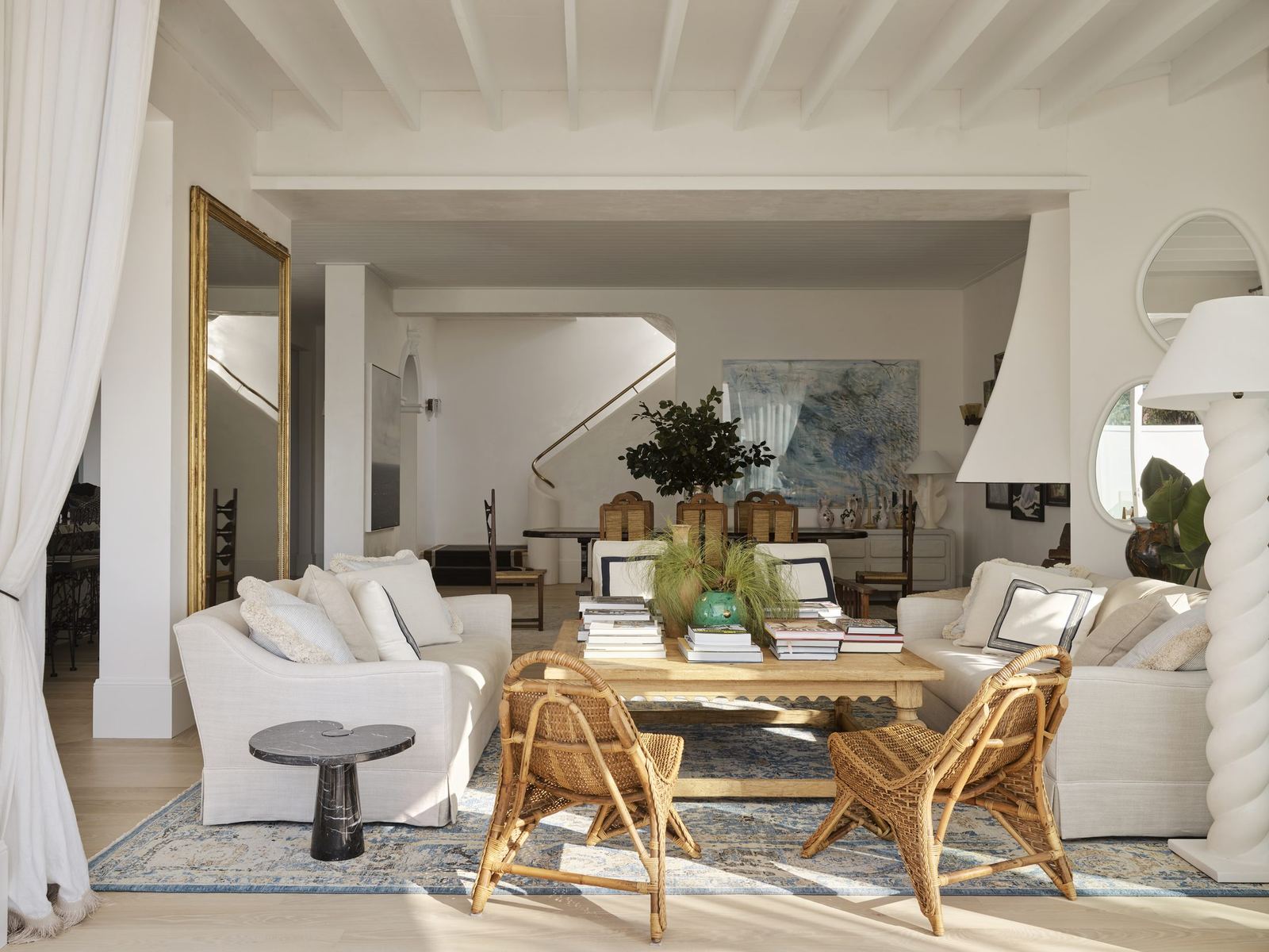 Vaucluse, sitting room with gilt mirror, rattan chairs and floor-length curtains, built by HP Constructions with Alexander & Co
