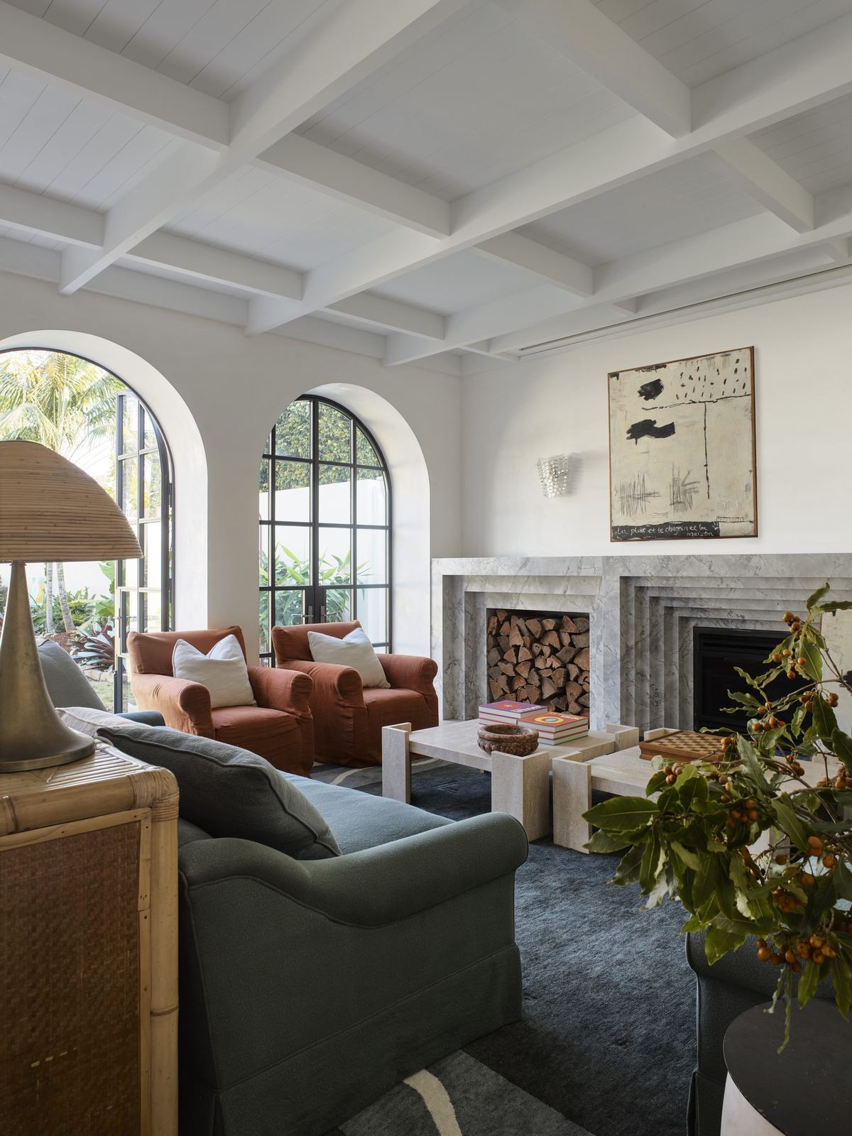 Vaucluse, living room with arched window, fireplace and upholstered armchairs, built by HP Constructions with Alexander & Co