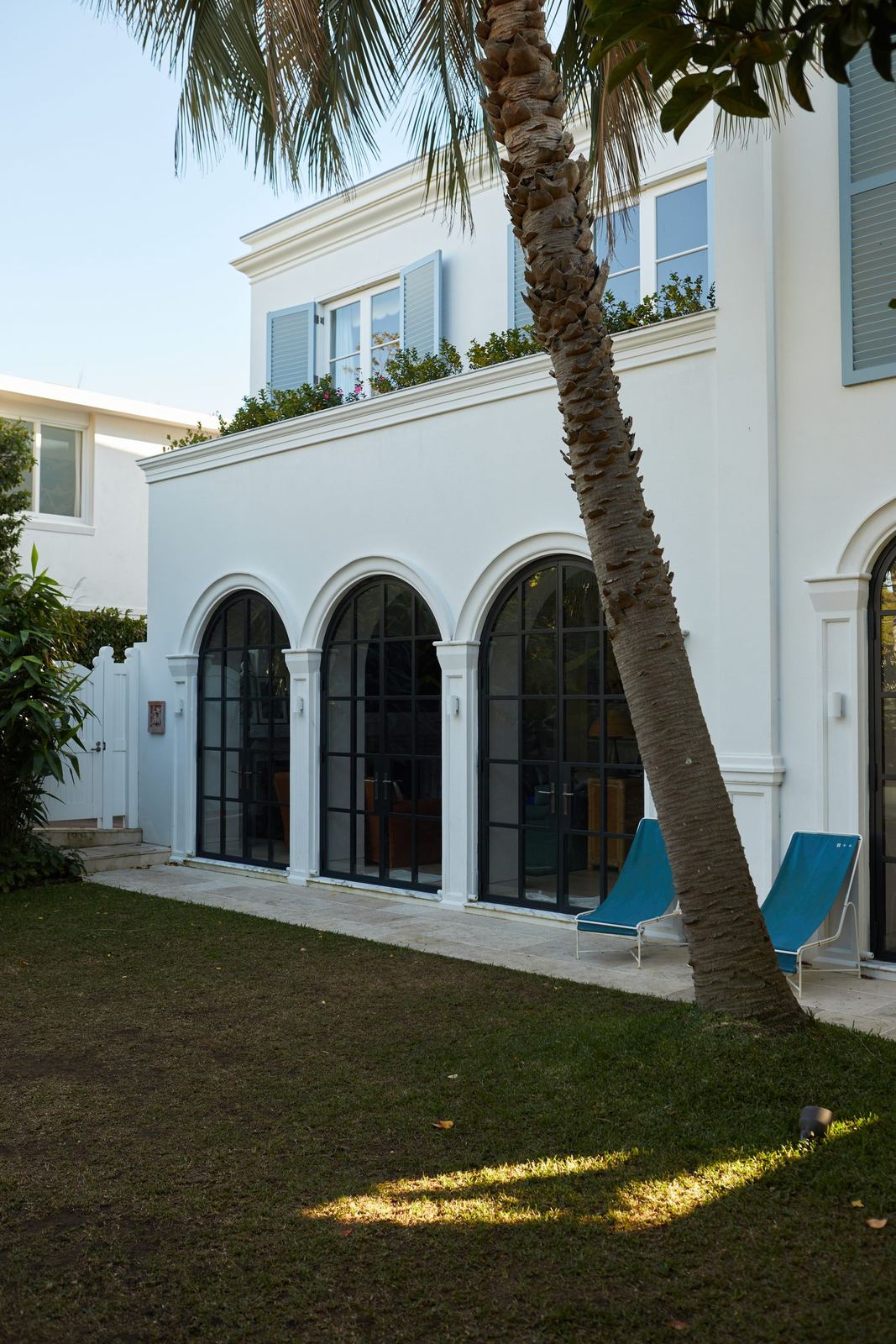Vaucluse, rear exterior with arched windows, lawn and palm tree, built by HP Constructions with Alexander & Co