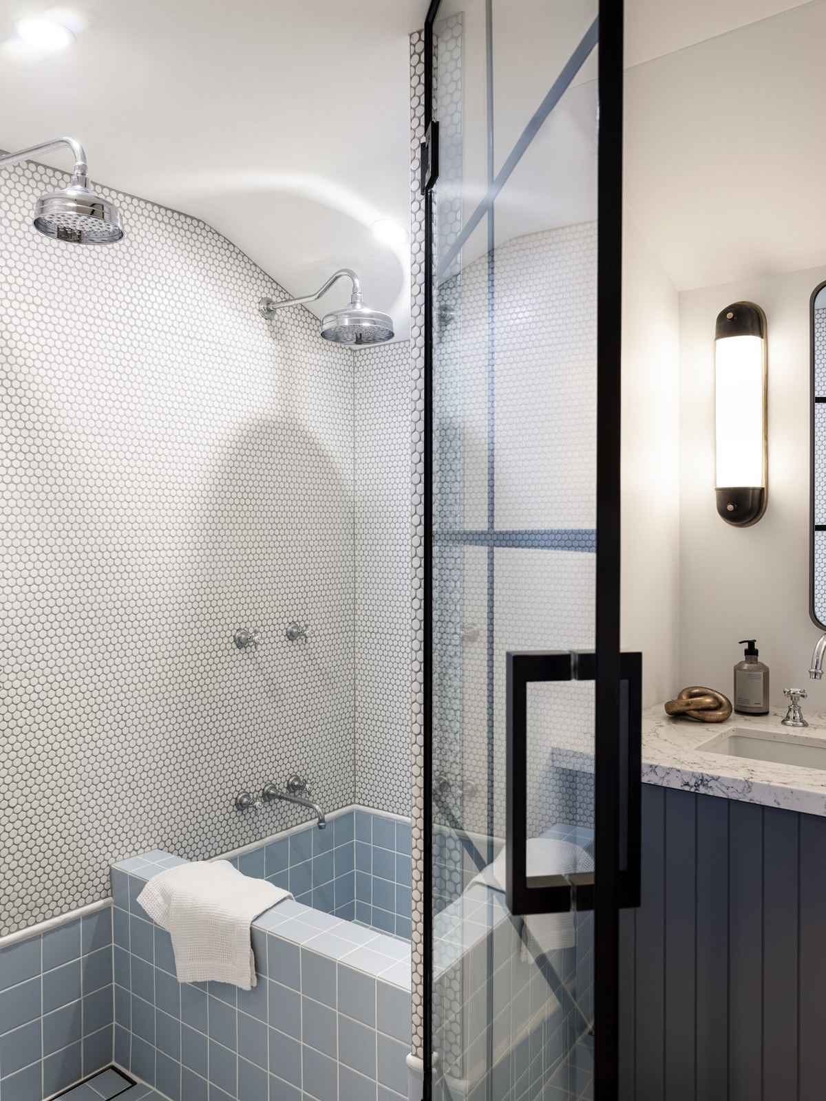 Willoughby, bathroom with blue-tiled bath and framed glass shower, built by HP Constructions with Alexander & Co