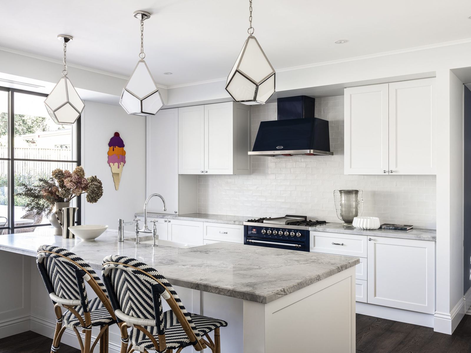Willoughby, kitchen with marble island, rattan stools and black range, built by HP Constructions with Alexander & Co